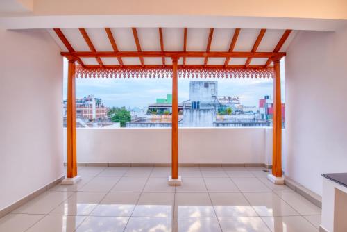 a view from a room with a large window at La Maison Charu in Puducherry