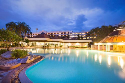 a large swimming pool in front of a building at The Imperial Hotel & Convention Centre Phitsanulok in Phitsanulok