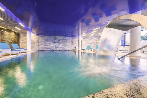 a swimming pool with a water slide in a building at Silver Mountain Apartment A32 - 3 rooms 3 bathrooms in Poiana Brasov