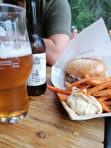 a hamburger and french fries and a bottle of beer at 1861 Châtel Hostel in Châtel