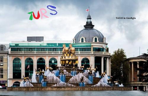 a building with a fountain in front of a building at Anna'S Home in Kutaisi