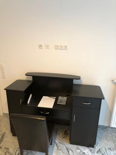 an office with a black desk and a chair at Industriestraße in Belm in Belm