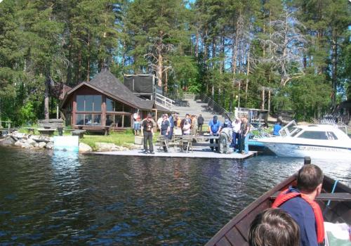 a group of people on a boat in the water at Herranniemi Guesthouse in Vuonislahti