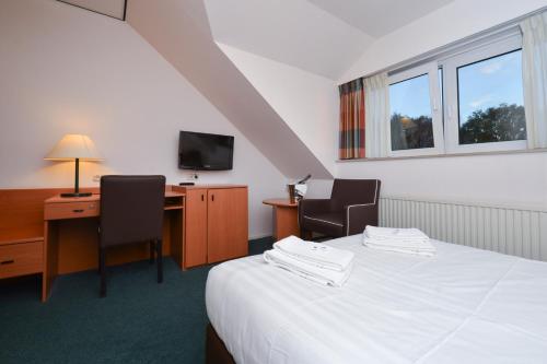 Ένα ή περισσότερα κρεβάτια σε δωμάτιο στο Fletcher Landhotel Bosrijk Roermond