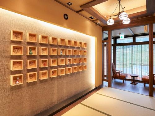 a room with a wall with paintings on it at Yukinohana in Yuzawa
