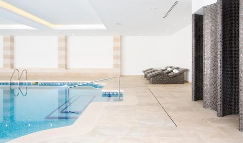 a pool in the middle of a room with a couch at Grupotel Orient in Playa de Palma