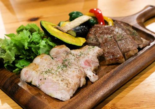 a plate of food with meat and vegetables on a table at Pension Kamifuji in Osaki