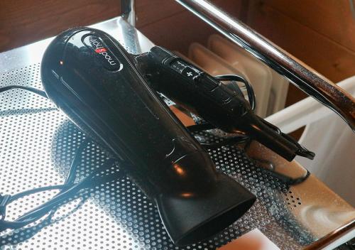 a black remote control sitting on top of a table at Pension Kamifuji in Osaki