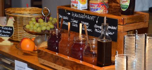 a counter with jars of honey and fruit on it at Seehotel Gut Dürnhof in Rieneck