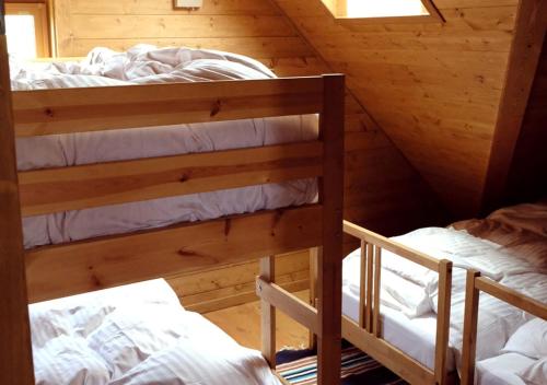 a bedroom with two bunk beds in a cabin at Pension Kamifuji in Osaki