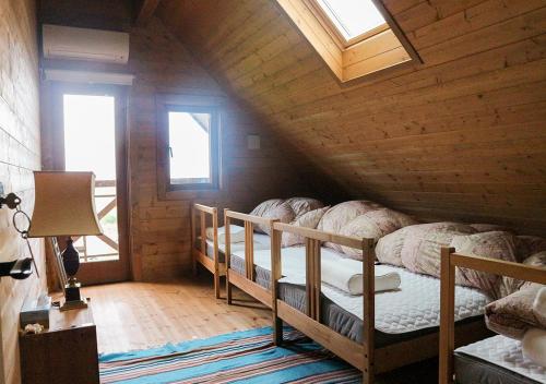 a bedroom with two bunk beds in a wooden cabin at Pension Kamifuji in Osaki