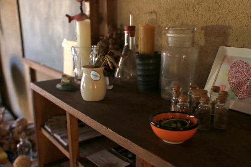 a wooden counter with bottles and candles on it at Koyado Namiji in Matsue