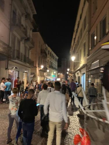 a group of people walking down a street at night at Casa Serena in Solonghello