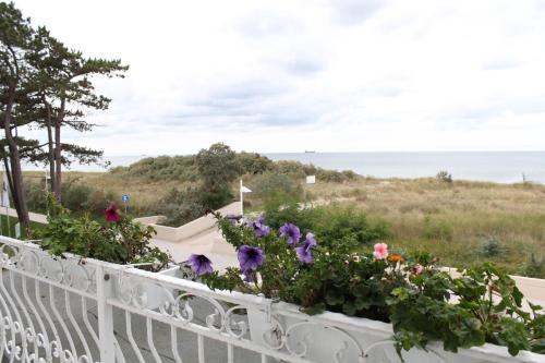 
a view from the balcony of a house overlooking the ocean at Hotel Stolteraa in Warnemünde
