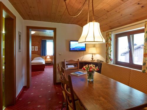 a dining room with a table with flowers on it at Appartementhaus Holiday in Lech am Arlberg