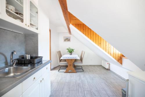 a kitchen with a sink and a table at Apartment & Room Pristov in Žirovnica