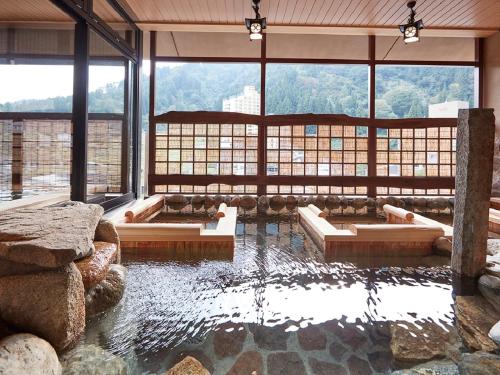 a room with a pool of water in a building at Yukinohana in Yuzawa