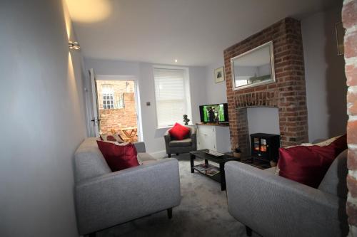a living room with two couches and a tv at 1 Steam Packet Cottage in Canterbury