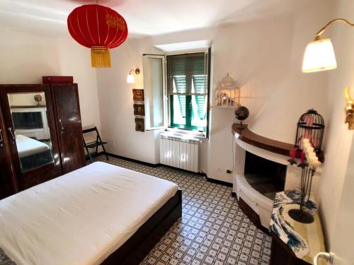 a bedroom with a bed and a window and a fireplace at La Terrazza di Re Scarlino in Scarlino