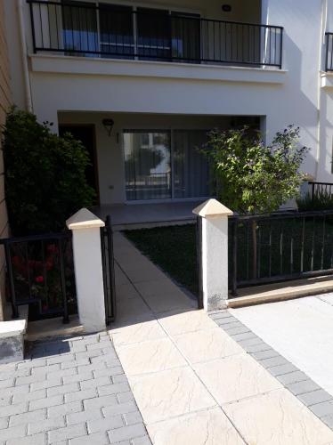 a building with a fence and a walkway at Sunrise Beach Club (Hera B6@) in Kalecik