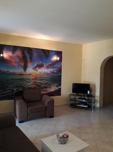 a living room with a couch and a painting on the wall at Sunrise Beach Club (Hera B6@) in Kalecik