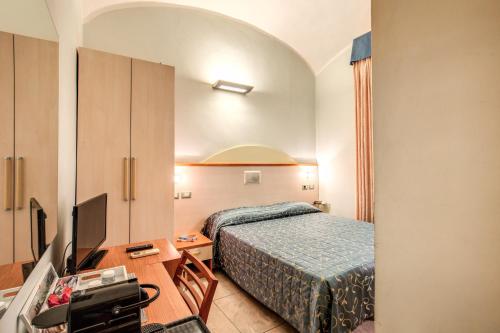 a hotel room with a bed and a tv at Casa Carra in Rome