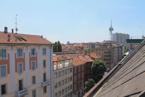 a view of a city from the roofs of buildings at Hotel Mozart in Milan