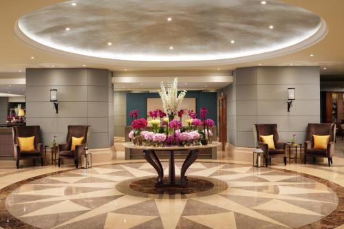 a lobby with a large display of flowers on a table at Corinthia Lisbon in Lisbon