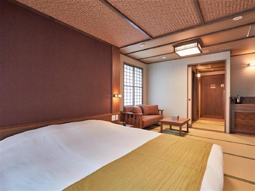 a bedroom with a bed and a living room at Yukinohana in Yuzawa