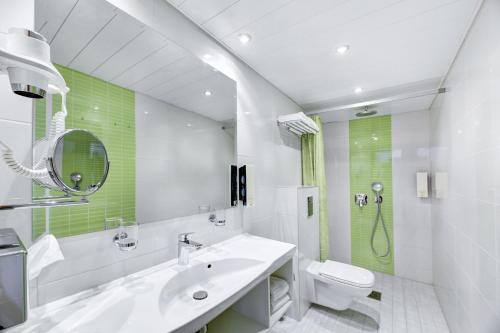 a bathroom with a sink and a toilet and a shower at Pärnu Hotel in Pärnu