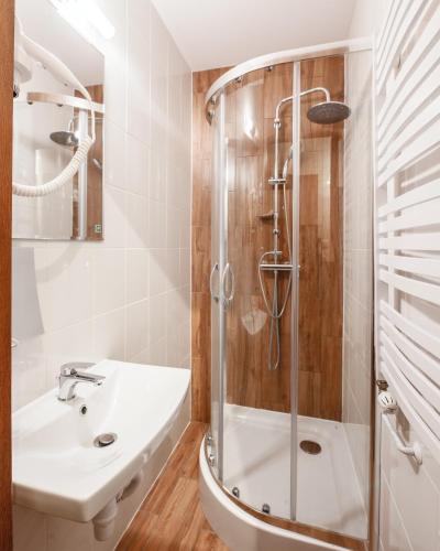 a bathroom with a shower and a sink at Ginger ApartHostel in Krakow