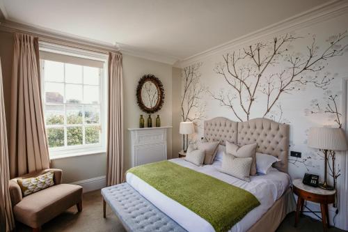 a bedroom with a large bed and a window at The George Hotel and Beach Club in Yarmouth