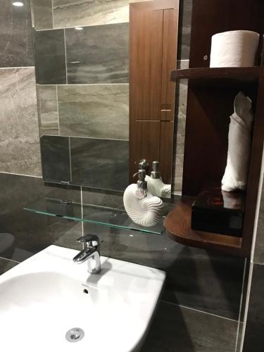 a bathroom with a sink and a mirror at Chez Mimosa Petite - Free Laundry in Ho Chi Minh City
