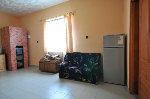a living room with a chair and a refrigerator at Gergely Tanya in Garabonc