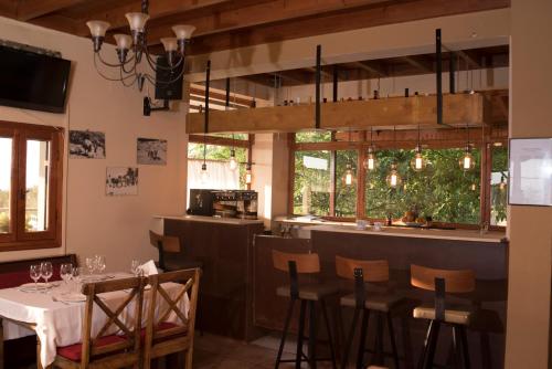 a dining room with a table and a bar at T'Aloni in Chortáta