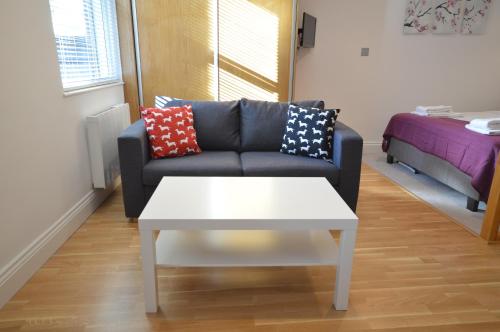 a living room with a couch and a coffee table at 3B Soho Studios 3rd floor by Indigo Flats in London