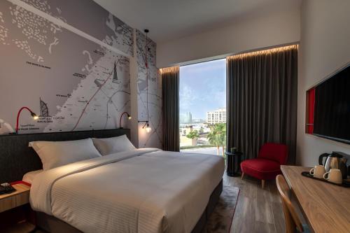 a hotel room with a large bed and a window at IntercityHotel Dubai Jaddaf Waterfront in Dubai