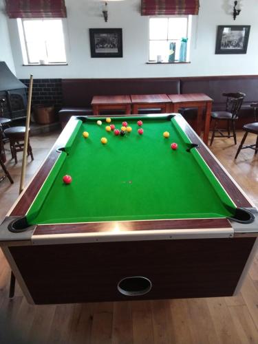 a pool table with balls on it in a room at The North Pole in Drumfree