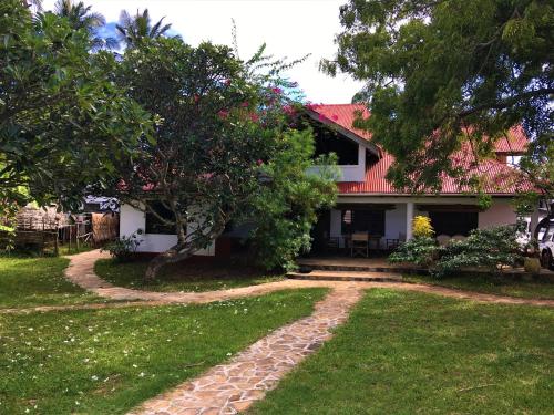 a house with a pathway leading to the front yard at Villa Matalai in Tanga