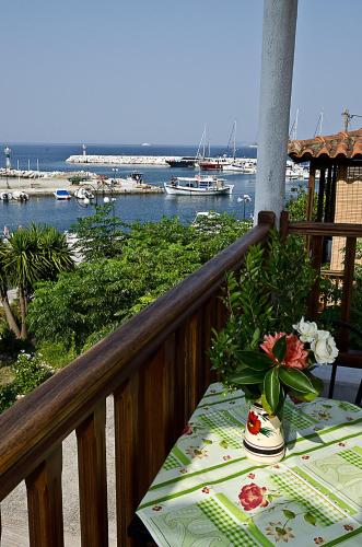 a table on a balcony with a view of the ocean at Mira Mare in Neo Klima