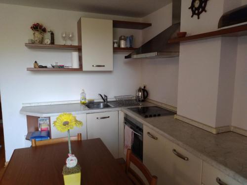 a kitchen with a table with a sunflower on it at Central Residence in Portorož