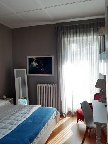 a bedroom with a bed and a window and a chair at Boutique Hotel Palazzo Corso Umberto in Boiano