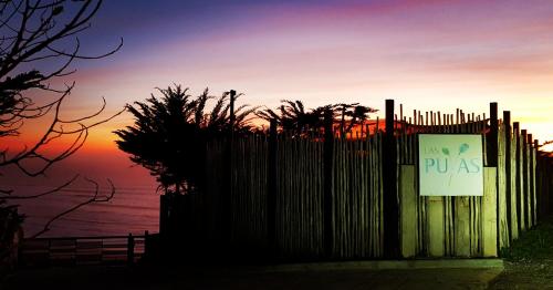 a fence with a sign that reads new pax at Tiny Apartment Las Puyas Ocean View in Boca Pupuya