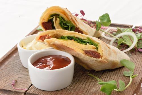 a sandwich on a plate with a dipping sauce at Kamienica Poznańska 7 in Bydgoszcz