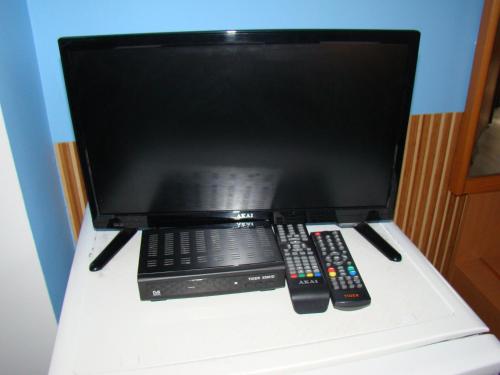 Uma televisão e/ou sistema de entretenimento em Guest House Uzhgorod