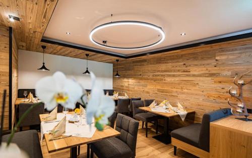 a restaurant with wooden walls and tables and chairs at Gasthof Furtner in Rohr im Gebirge