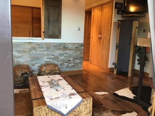 a living room with a table and a fireplace at RESIDENCE LE PACHA Courchevel 1850 in Courchevel