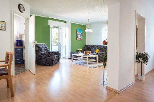 a living room with two chairs and a table at Regenbogen-Appartement in Bad Krozingen