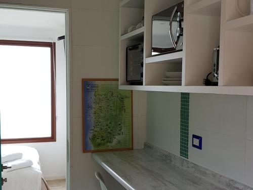 a bathroom with a sink and a map on the wall at Tiny Apartment Las Puyas Ocean View in Boca Pupuya