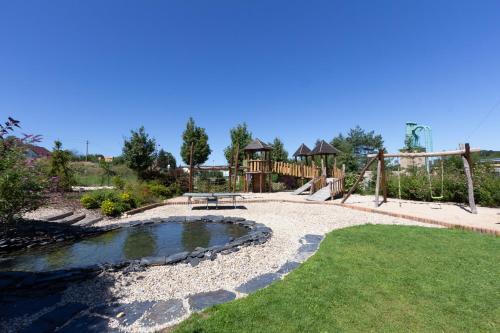a park with a playground and a swing at Apartmány PEMI Potštejn in Potštejn